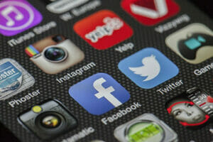 Social Media (instagram, Yelp, Facebook, Twitter Logos on Smart Phone Screen)