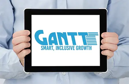 Person in a Light Blue Shirt Holds a Tablet Showing the Gantt Logo and the Tagline 'smart, Inclusive Growth'. Person in a Light Blue Shirt Holds a Tablet Showing the Gantt Logo and the Tagline 'smart, Inclusive Growth'.