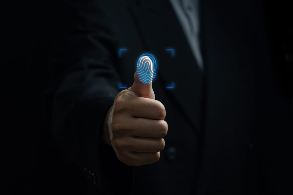 Businessman Scanning His Thumb Print for Access Businessman Scanning His Thumb Print for Access