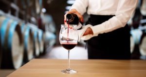 Women Pouring Wine into a Glass