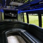 Luxurious Limousine Interior with Black Leather Wraparound Seating and Blue Led Lighting, a Wall-mounted Screen Showing 'belman Limousine' Logo. Luxurious Limousine Interior with Black Leather Wraparound Seating and Blue Led Lighting, a Wall-mounted Screen Showing 'belman Limousine' Logo.