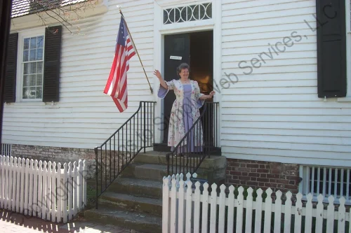 Docent waving from the Mary Washington House